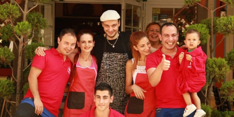 The family and staff of the hotel outside the restaurant
