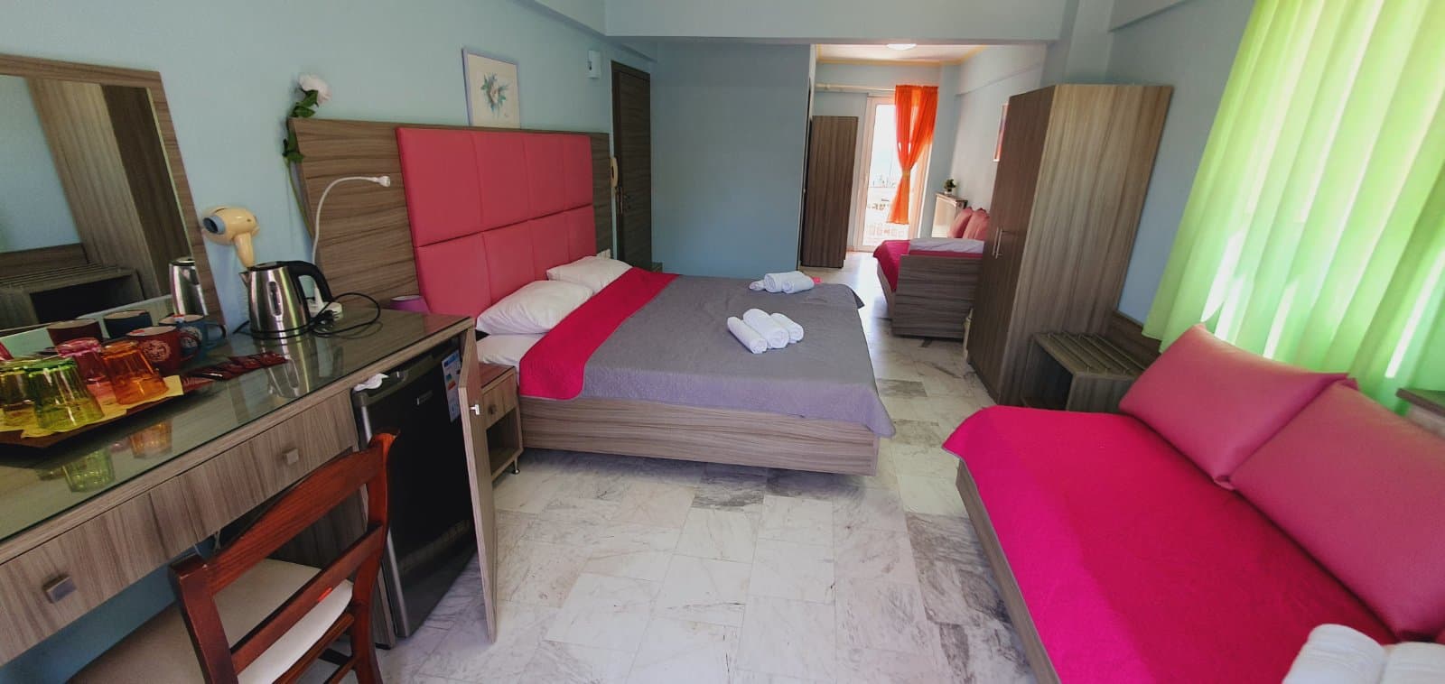 Twin room with a kettle, fridge and marble floor