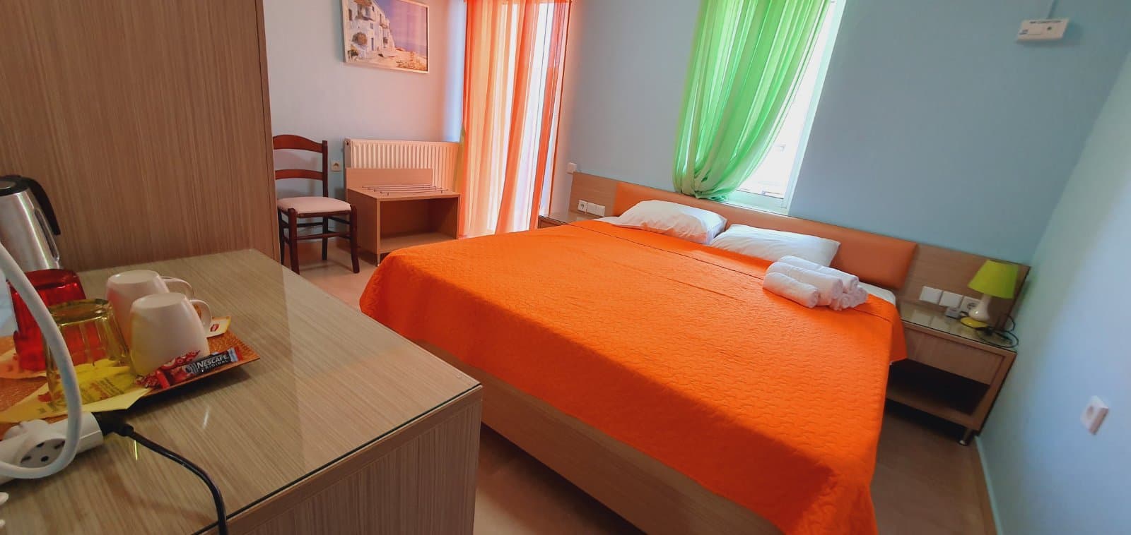 Guest room with the shutters open to the morning