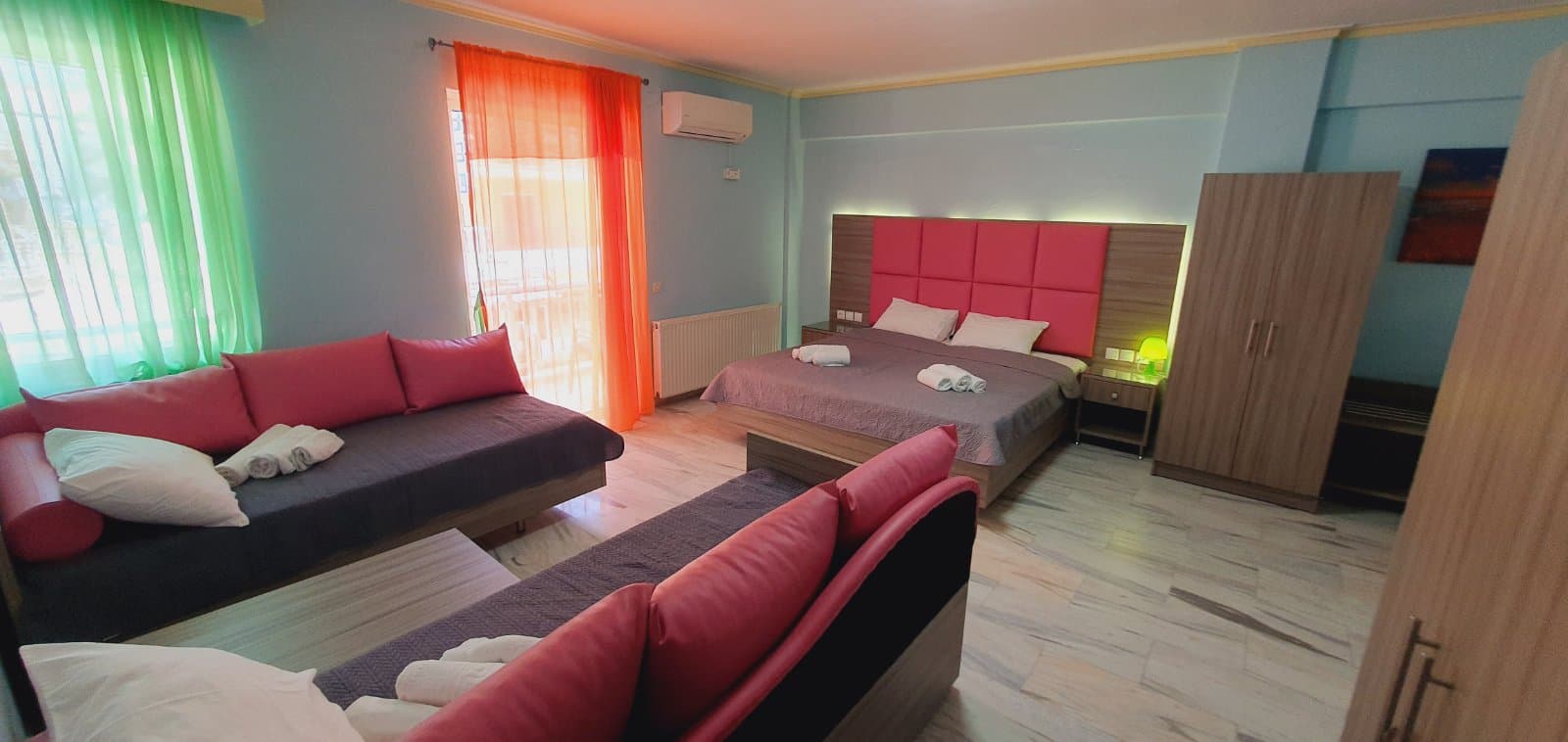 Bedroom with curtains drawn back from the balcony