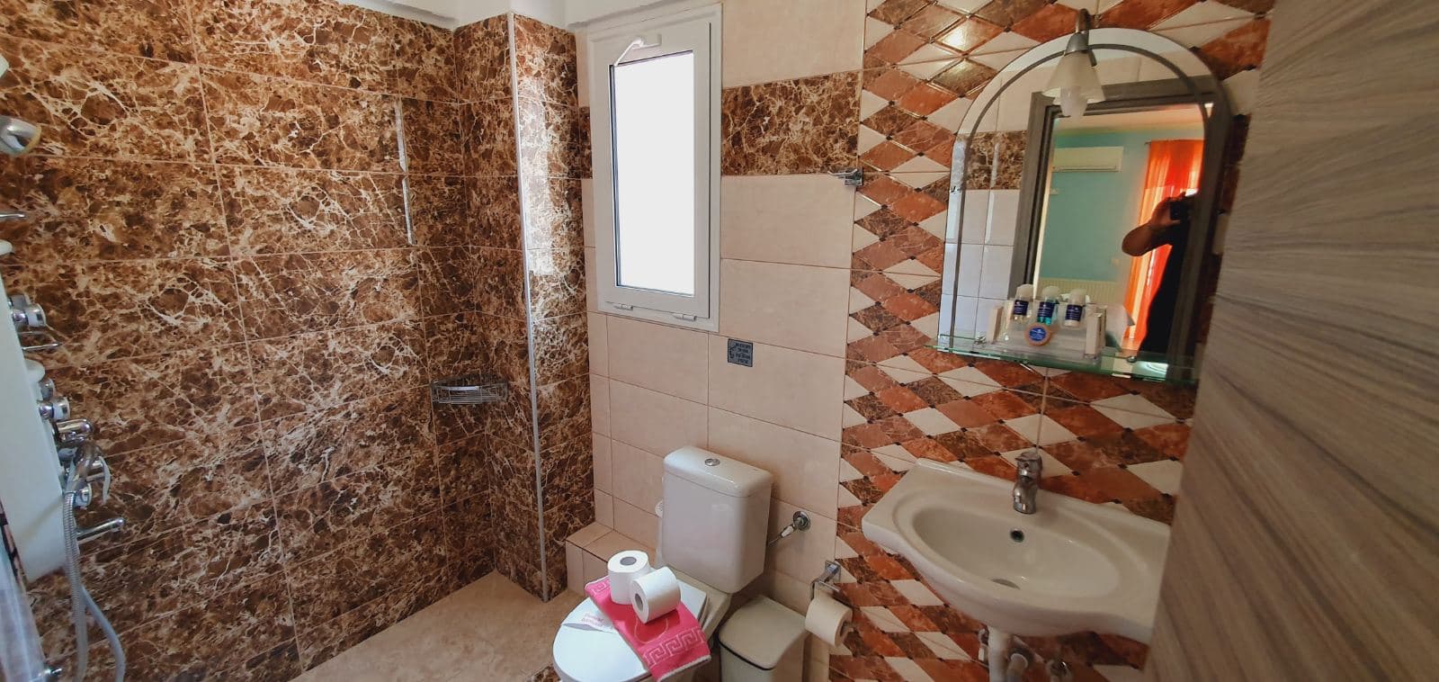 Double room with orange curtains open to the balcony