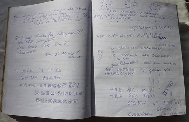Pages of the hotel guest book, filled with handwritten messages